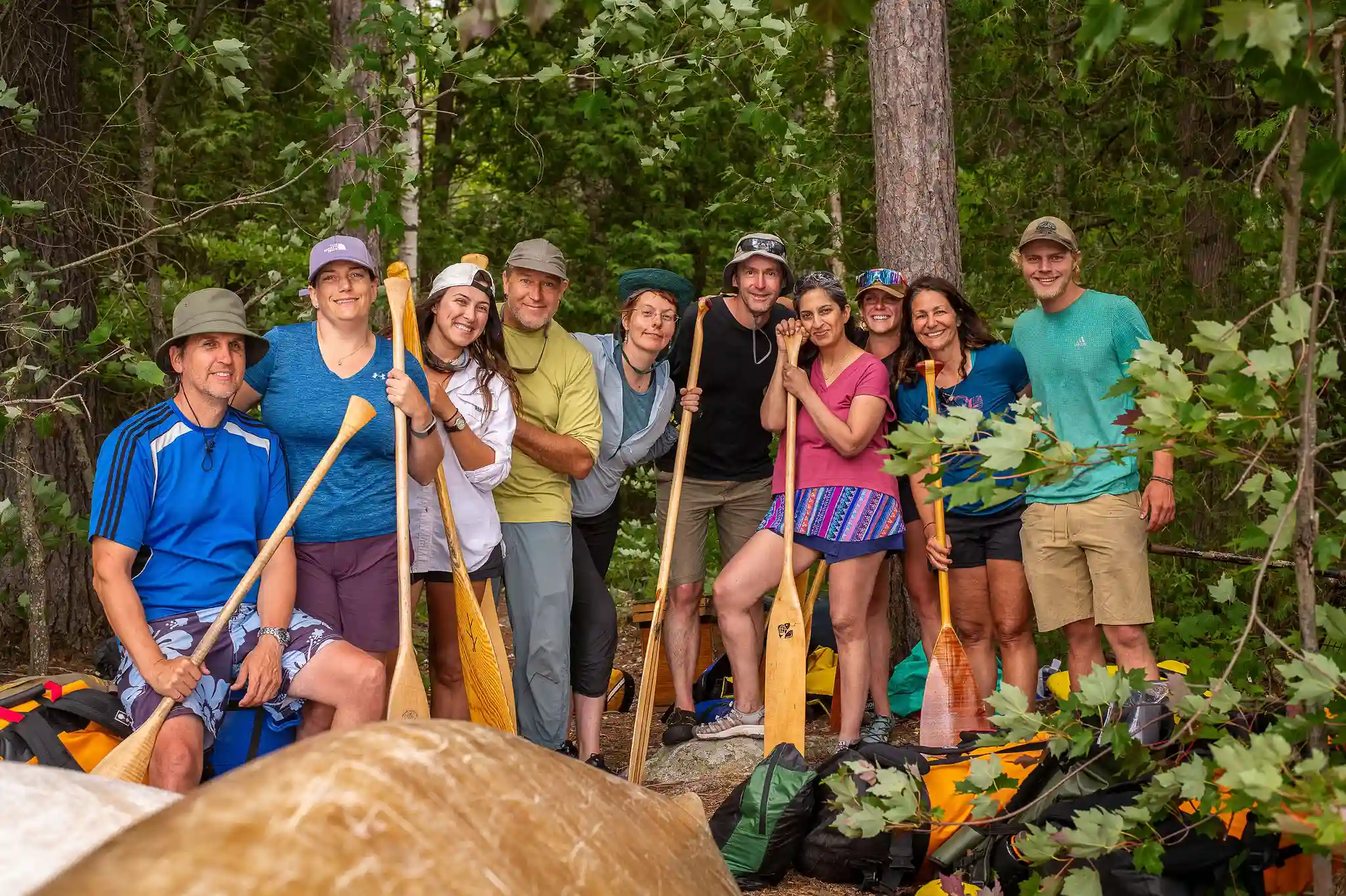 Group of Karibu travelers with canoe paddles.
